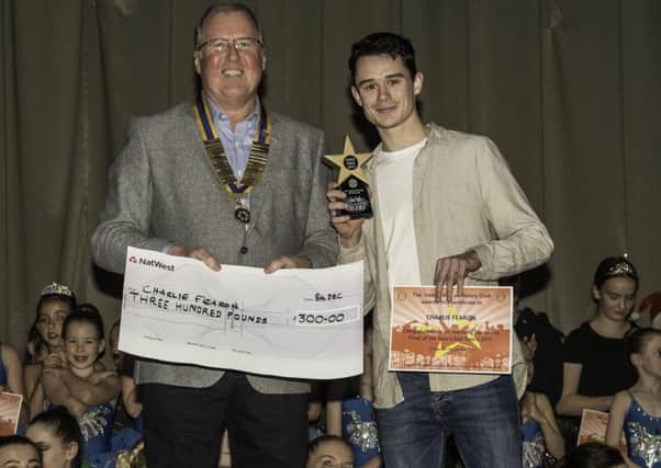 President of the Vale of Belvoir Rotary Club Adrian Cresswell presenting Charlie Fearon with his trophy and Â£300 for winning PHOTO: Supplied