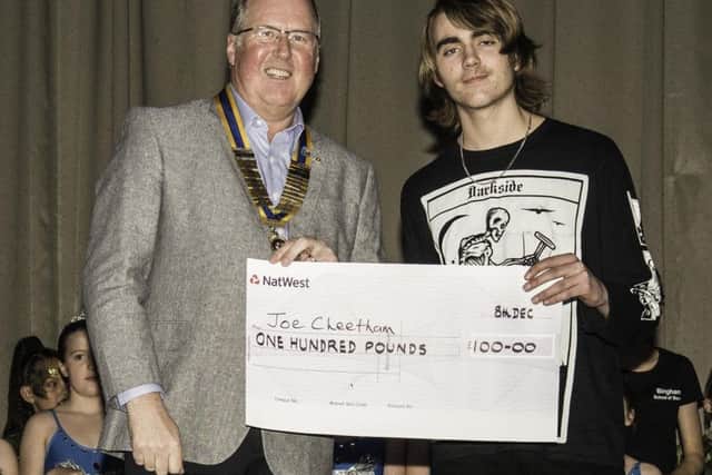 President of the Vale of Belvoir Rotary Club Adrian Cresswell presenting Joe Cheetham with £100 for finishing third PHOTO: Supplied
