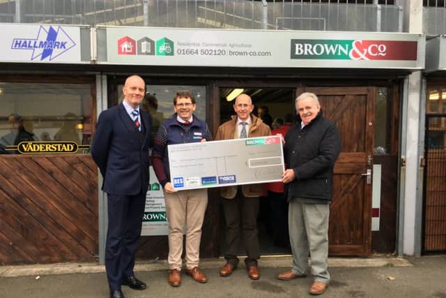 Representatives of Brown & Co Melton Mowbray present cheque for £3,000 to Derbyshire, Leicestershire and Rutland Air Ambulance's Roy Stevenson PHOTO: Supplied