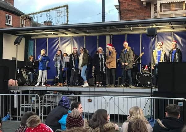 Students promoting their Boogie Nights 'The 70's Musical' show at Melton's Christmas market PHOTO: Supplied