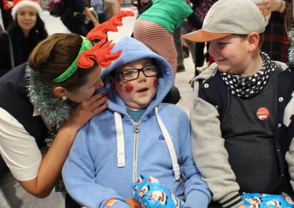 William Billingsley (11), from Melton, with an East Midlands Airport hostess, watched by brother Finley (7) PHOTO: Supplied