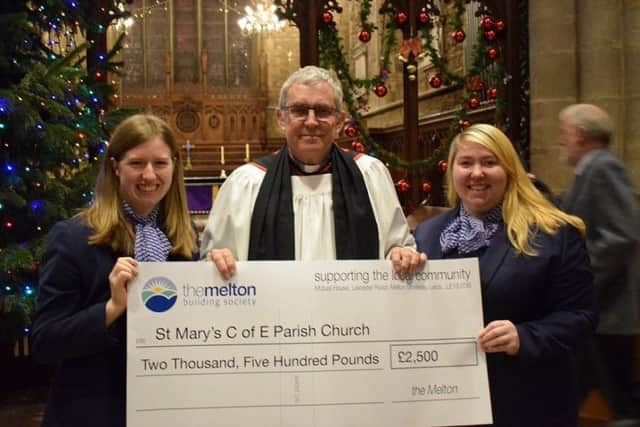 Rev Kevin Ashby is presented with a cheque by representatives from The Melton Building Society towards the Re-Ordering Project at St Mary's Church
PHOTO PHIL BALDING EMN-171218-173854001