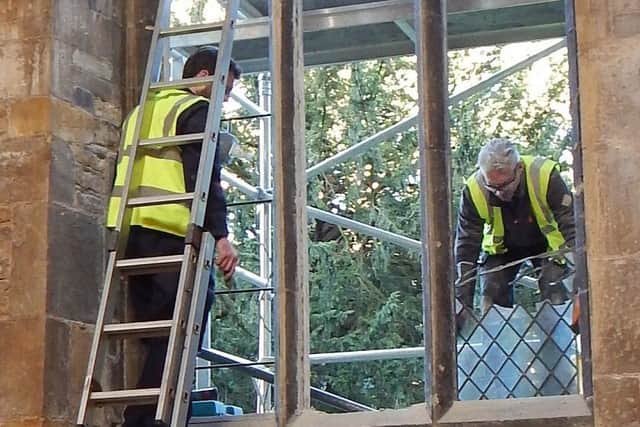 Workmen install the new stained glass window at St Mary's Church in Melton.
PHOTO PHIL BALDING EMN-171218-175623001