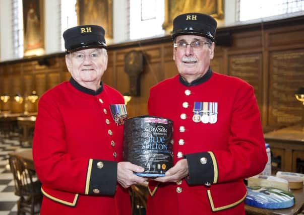 Two Chelsea Pensioners show off Stilton cheese donated by Long Clawson Dairy as part of the veterans' annual celebration of British cheesemakers EMN-171220-114404001