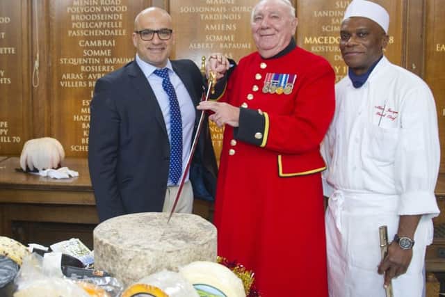 Chelsea Pensioner Leo Tighe carries out the ceremonial cutting of the cheese at the annual celebration of UK cheesemakers EMN-171220-122258001