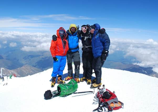 Chris Foster (right), of Long Clawson, with three team members at the summit of Mount Elbrus in Russia, Europe's tallest peak.
Photo supplied EMN-171220-112401001