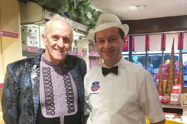 Artist Graham Short, with Dickinson & Morris' Ye Olde Pork Pie Shoppe's Stephen Hallam, when he returned to the shop a year after spending a limited edition fiver worth up to £50,000 EMN-171221-153731001