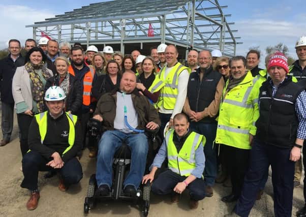 Matt Hampson and his foundation members and partners with former England rugby captain Mike Tindall, at the topping out ceremony for the Get Busy Living Centre at Burrough-on-the-Hill EMN-180301-090506001