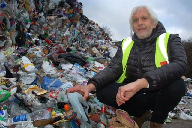 Melton Council's Raman Selvon with the huge mound of recyclable materials discarded by Melton residents over the festive season, at the Lake Terrace tip EMN-180801-172025001