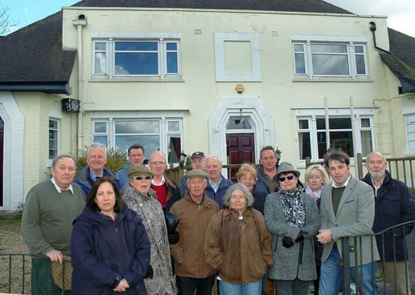 Melton borough councillor Leigh Higgins outside The Fox Inn at Thorpe Satchville and villagers who want to see it reopen as a viable business EMN-180901-153203001