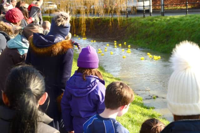 Villagers cheer on the winning ducks as they race along the Rearsby Brook PHOTO: Lionel Heap