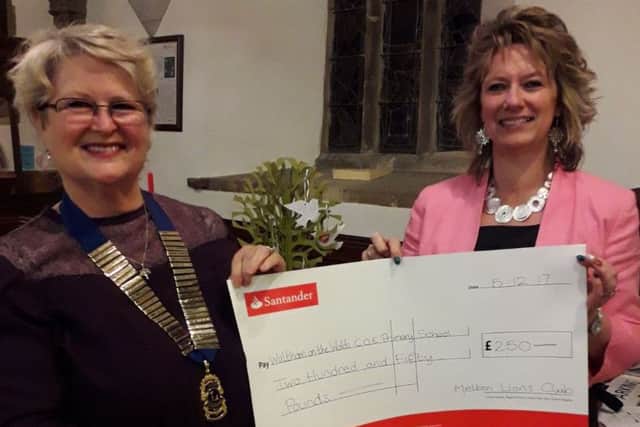 Sabrina Tate, Melton Mowbray Lions president presents a cheque for Â£250 to Julie Hopkins, head teacher of Waltham on the Wolds Primary School PHOTO: Supplied