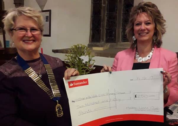 Sabrina Tate, Melton Mowbray Lions president presents a cheque for Â£250 to Julie Hopkins, head teacher of Waltham on the Wolds Primary School PHOTO: Supplied
