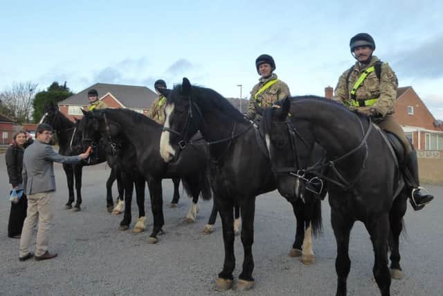 Horses from the Household Cavalry and service personnel from Melton's Defence Animal Centre visit a service at the Welby Lane Mission Church. Pastor Sam Osborne and his wife Jenny are pictured feeding the horses EMN-180115-102445001