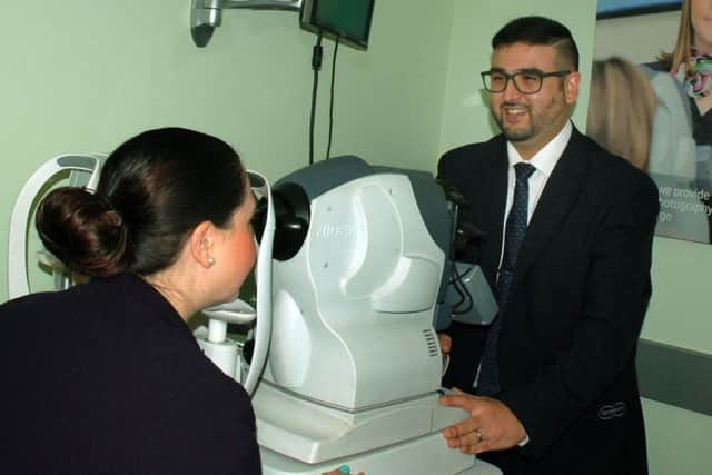 Dispensing optician manager Rajiv Pancholi with a customer in one of the new diagnostic suites PHOTO: Tim Williams