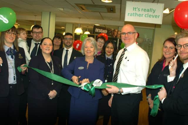 Specsavers co-founder Dame Mary Perkins cuts the ribbon with Melton Specsavers director Marshall Bradley and staff PHOTO: Tim Williams