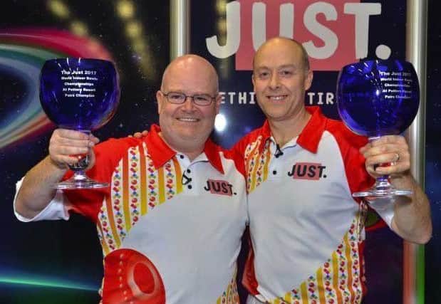 Les Gillett (left) celebrates his second world pairs title with Jason Greenslade last year EMN-180116-114459002
