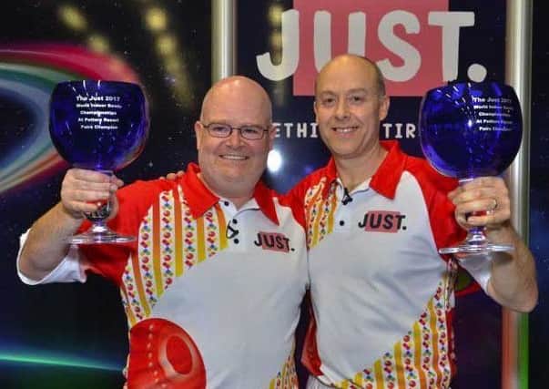 Les Gillett (left) celebrates his second world pairs title with Jason Greenslade last year EMN-180116-114459002