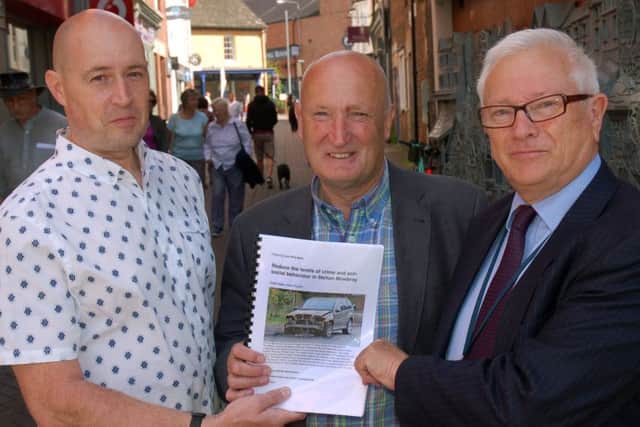 Resident Chris Fisher (left) hands over a petition to crime commissioner Lord Willy Bach (right) and Melton Council leader, Councillor Joe Orson, calling for action to tackle the recent upsurge in crime in the town EMN-181201-171336001