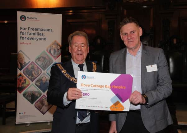 David Hagger presents donation to Chris Rowley PHOTO: Andy Green