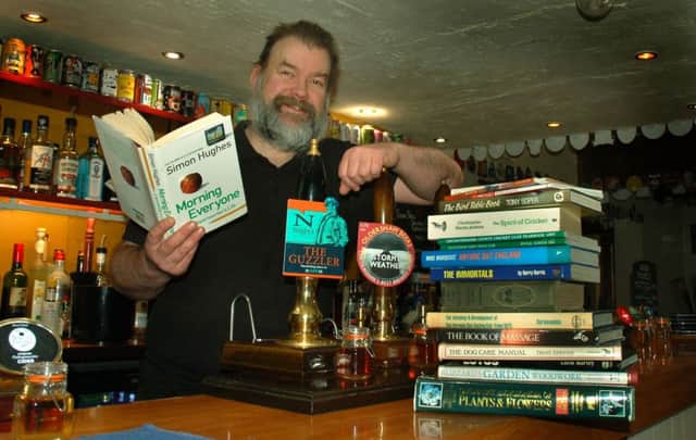 Geese and Fountain landlord Nick Holden with some of the reading to be found in the new library.