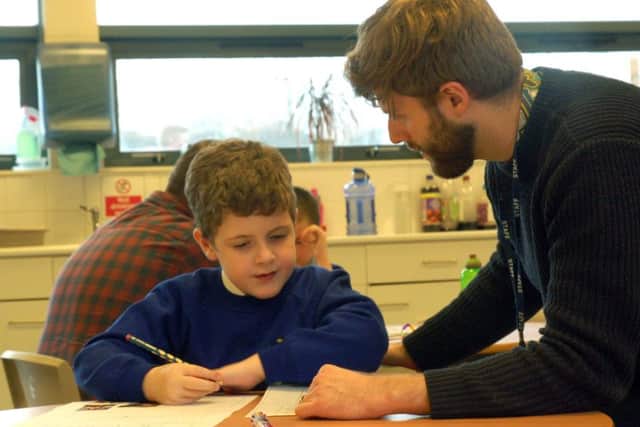 Teacher Robbie Hesketh works with a student at Birch Wood Area Special School at Melton EMN-180602-172553001