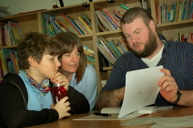 Teacher Phil Reeve with pupil Leon at Birch Wood Area Special School at Melton EMN-180602-172604001