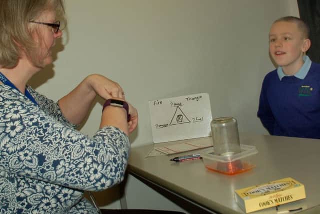 Pupil Ashton takes part in a science experiment with staff at Birch Wood Area Special School at Melton EMN-180602-172647001