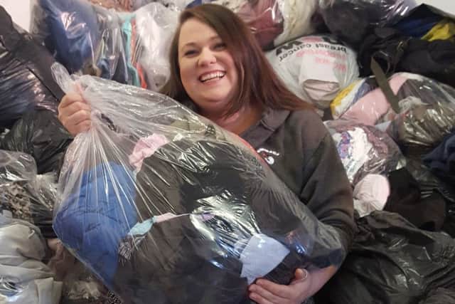 Emmaus's Hayley Gall with donated bags of clothing PHOTO: Supplied