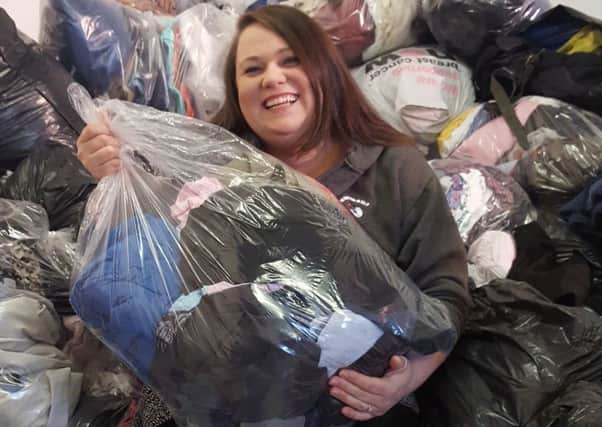 Emmaus's Hayley Gall with donated bags of clothing PHOTO: Supplied
