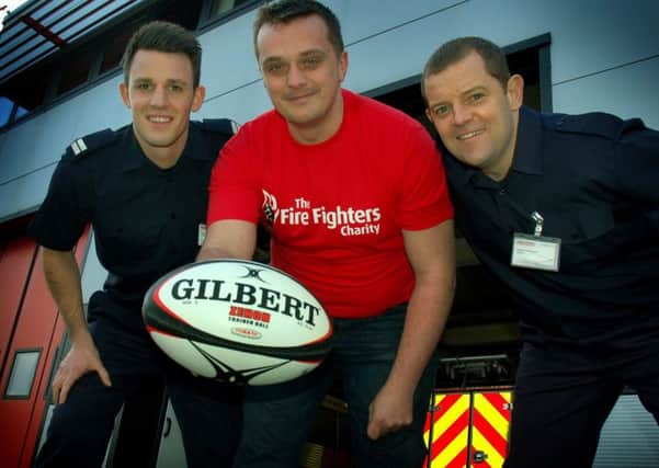 Firefighter James Marman gets in some practice for his charity marathon rugby match with collegues from the Melton station, Jamie Dawes and Steve Butterworth EMN-180223-112946001