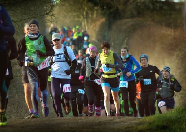 Runners climb out of the Vale of Belvoir to make their way through land on the Belvoir Estate EMN-180226-155504001