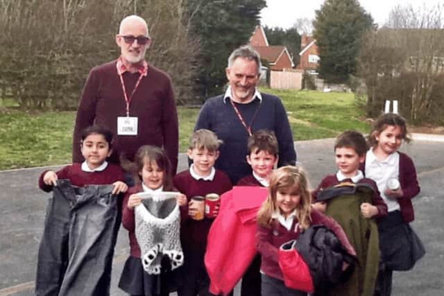 Class one youngsters show off their donated items for The Bridge charity PHOTO: Supplied