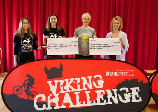 Jane Noad, incoming chairperson for the Viking Challenge Committee (blonde hair), presents Redmile head teacher Julie Hopkins (right), and Cally Keetley (dark hair) and Holly McCain (left) trustees from Nottinghamshire Wildlife Trust with their cheques PHOTO: Caroline Addison