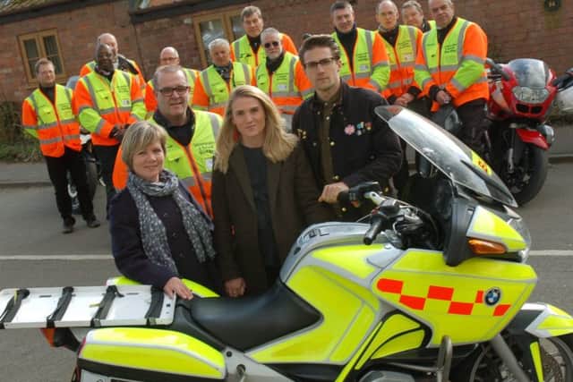 Sarah, Bryony and Luke Turner present their late father's motorbike to Leicestershire and Rutland Blood Bikes chairman Oliver Cufflin and his fellow volunteers EMN-180328-110811001