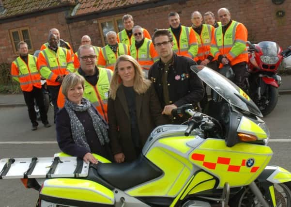 Sarah, Bryony and Luke Turner present their late father's motorbike to Leicestershire and Rutland Blood Bikes chairman Oliver Cufflin and his fellow volunteers EMN-180328-110811001