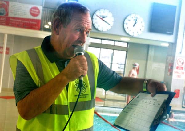 Tony Eaves keeps everyone up to date on the lengths completed PHOTO: Tim Williams
