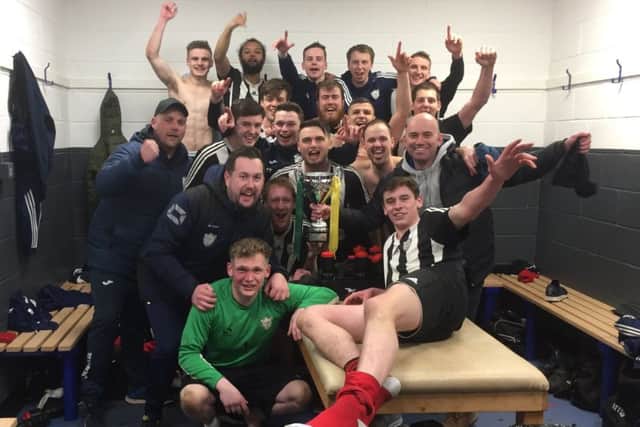 Wymeswold begin their dressing room celebrations with the cup EMN-180327-102757002