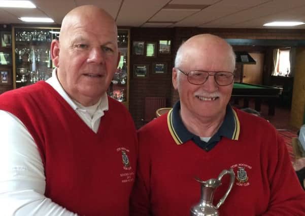 Seniors captain Brian White (left) presents the Winter Warmers trophy to Greg Ewart EMN-180327-185233002