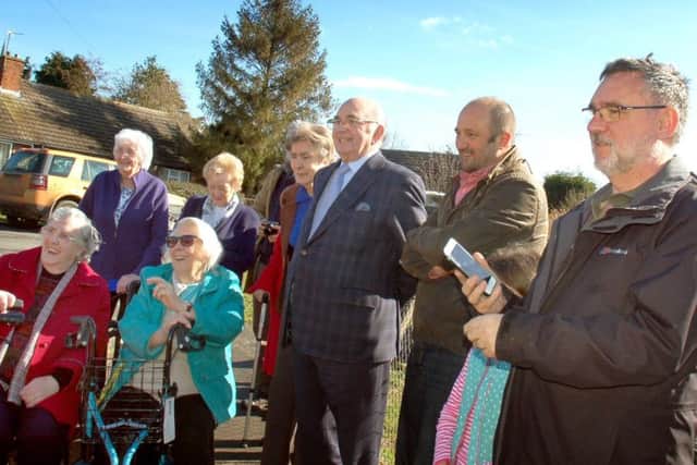 Villagers look on as Sir Alan Duncan officially opens the Friendly Bench at Bottesford with committee members Jason and Lyndsey Young, and Caroline Arthur EMN-180328-125152001