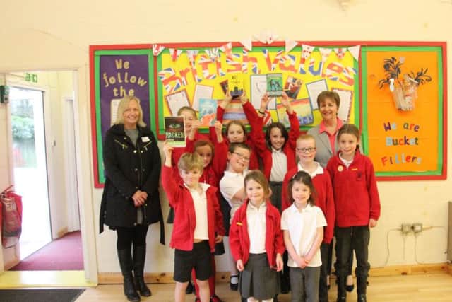 Dee Burton and Michelle Morris, owners of Melton Premier, at the school with the children PHOTO: Supplied