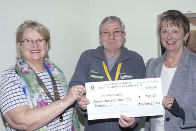 Sabrina Tate (left) and Barbara Fraser present their donation to a representative from the air ambulance charity PHOTO: Supplied