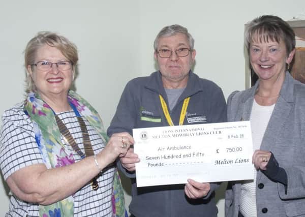 Sabrina Tate (left) and Barbara Fraser present their donation to a representative from the air ambulance charity PHOTO: Supplied