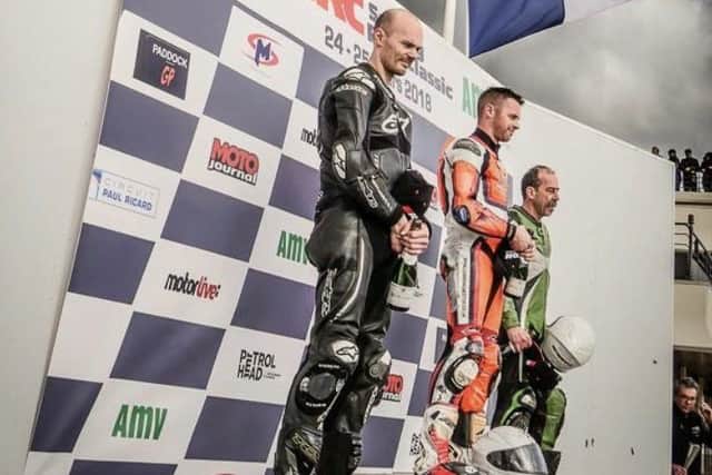 The Union Flag flies as Antony Hart climbs the top step of the podium EMN-180204-163729002