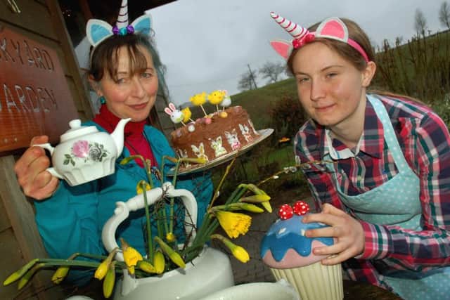 Anna Stasinska and Eve Lyon served up Easter cakes and tea for the visitors to the Mad Hatter's Tea Party PHOTO: Tim Williams