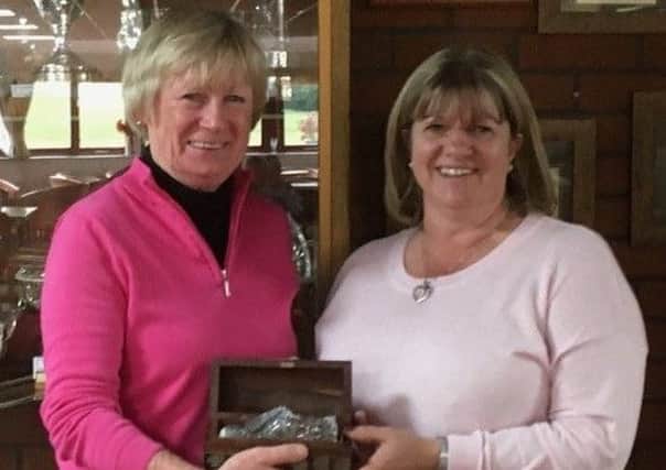 Pictured: Phillippa Smith receives the Early Birds Trophy from lady captain Pam Watson EMN-180304-190318002