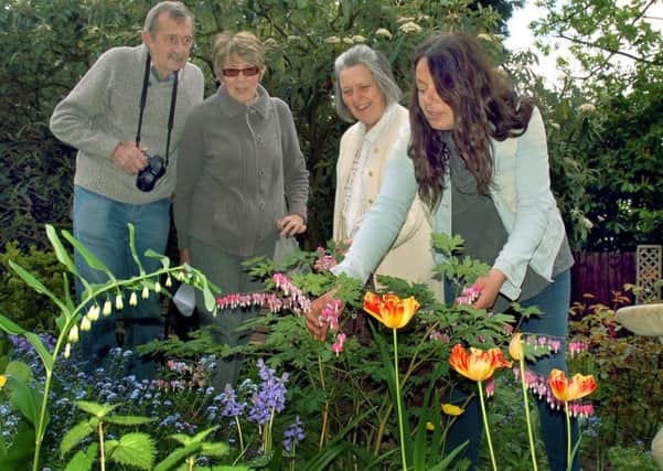 Owner of Tresillian House Alison Blythe shows Alan and Carole Hewitt around the flower beds with horticultural expert Christina Moulton PHOTO: Tim Williams