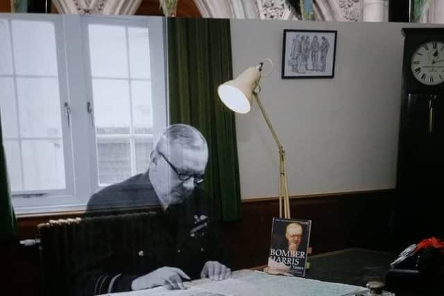 Brian Fare's drawing of a Bomber Command crew during the Second World War on the wall behind the Bomber Harris at the recreated office EMN-180404-150356001