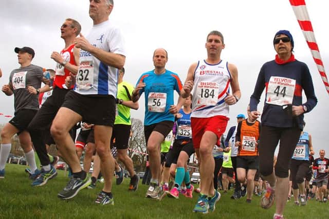 Runners filter out across a soggy Hose Village Hall playing field EMN-181004-152400002