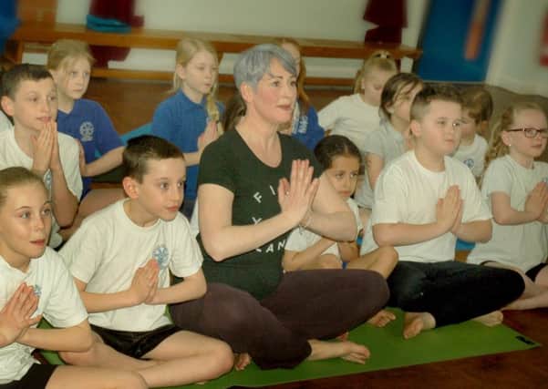 Yoga instructor Emma Ansell with pupils from Wymondham Primary School PHOTO: Tim Williams